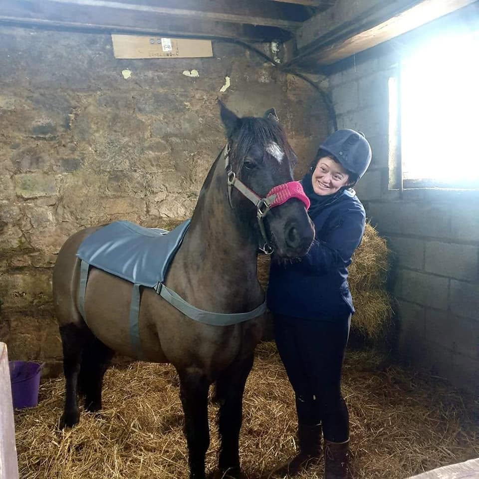 Stacy Harris-Wann, founder of YardLoop, with a horse at the yard
